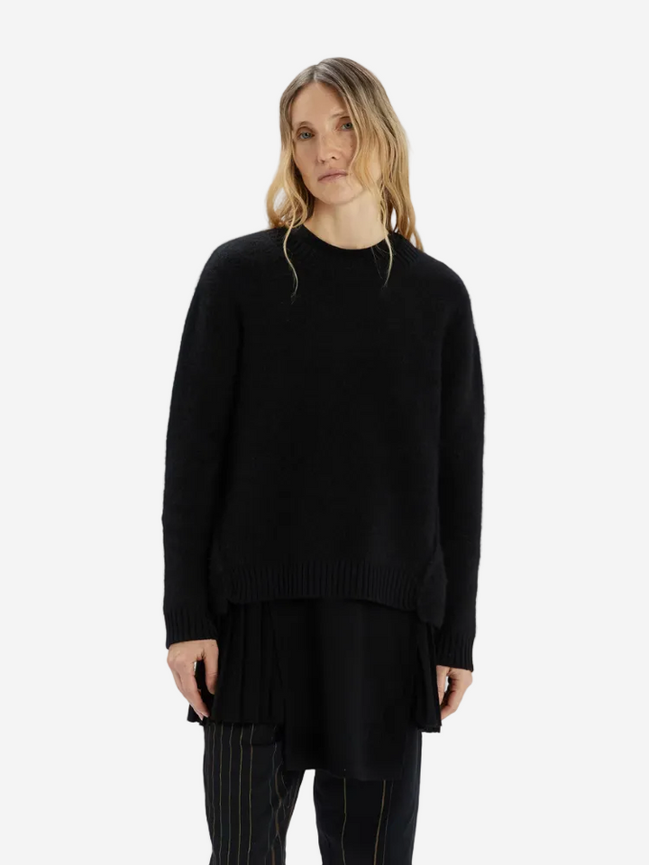 Woman wearing a black sweater and pants on a white background