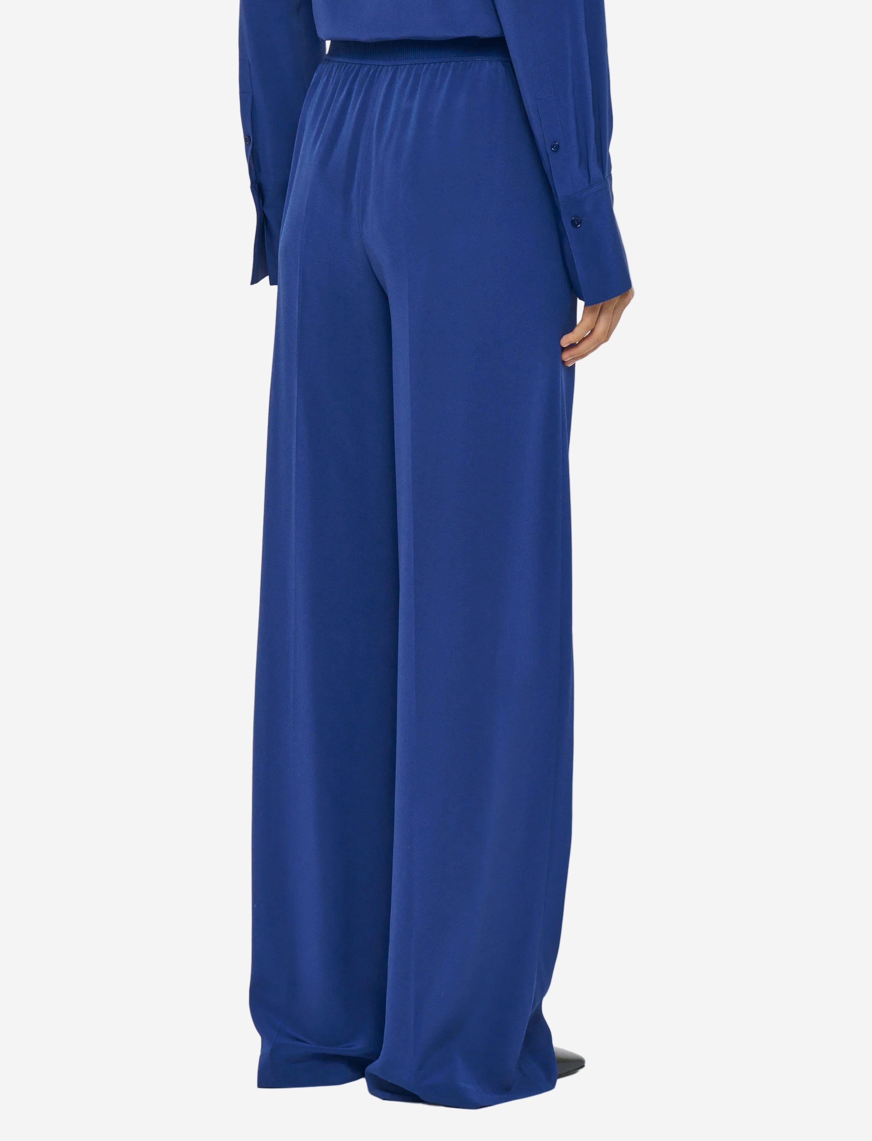 Blue outfit with wide-leg pants on a white background