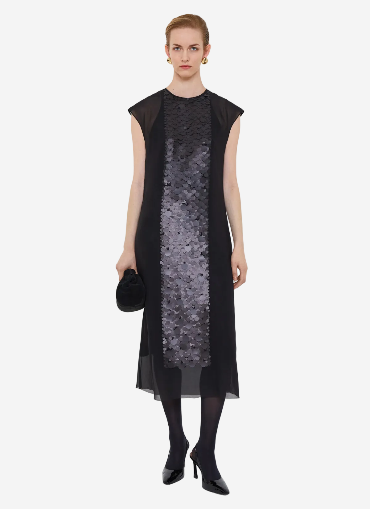 Woman wearing a black dress with a sequin panel on a white background