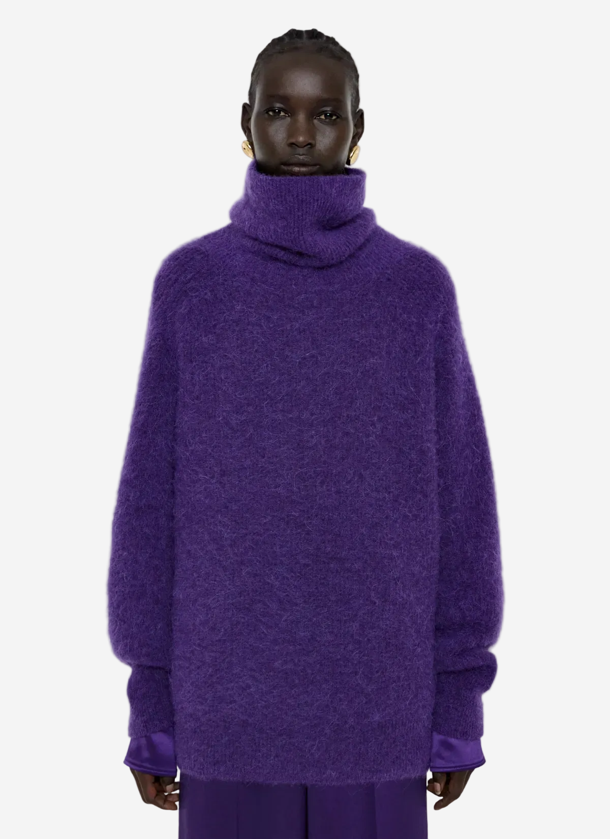 Person wearing a purple sweater on a light gray background