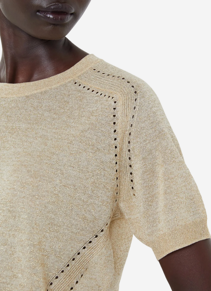 Beige knit top with cut-out details on a neutral background