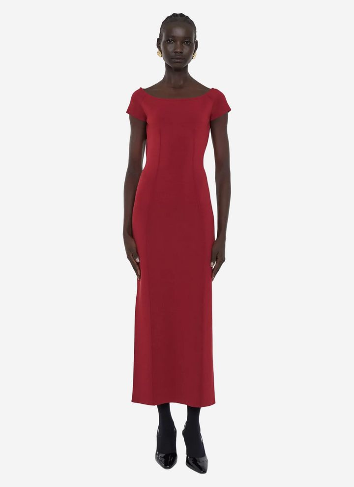 Red dress worn by a model on a white background