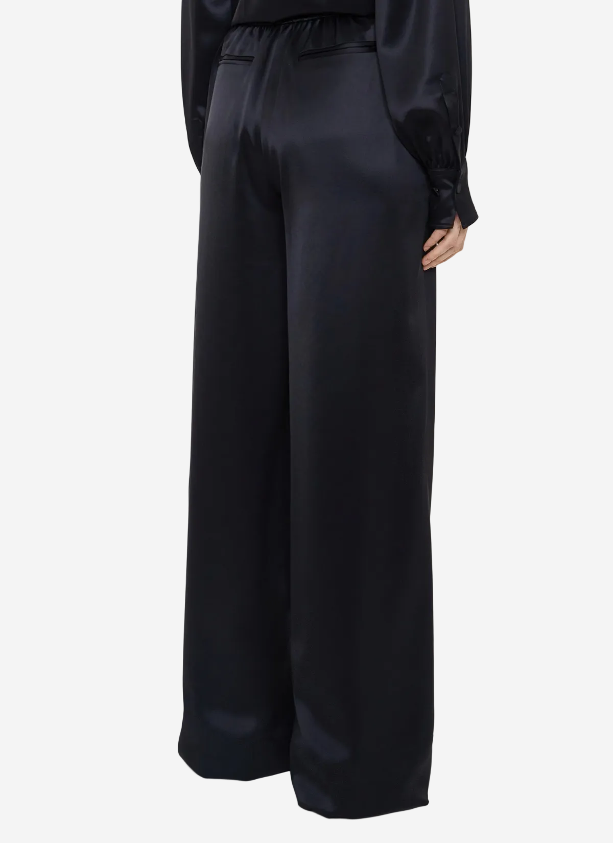 Black satin wide-leg pants on a white background