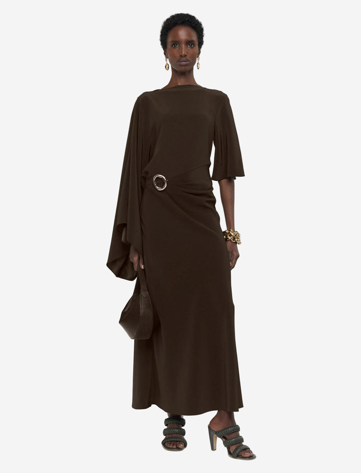 Woman wearing a brown dress with a belt on a white background