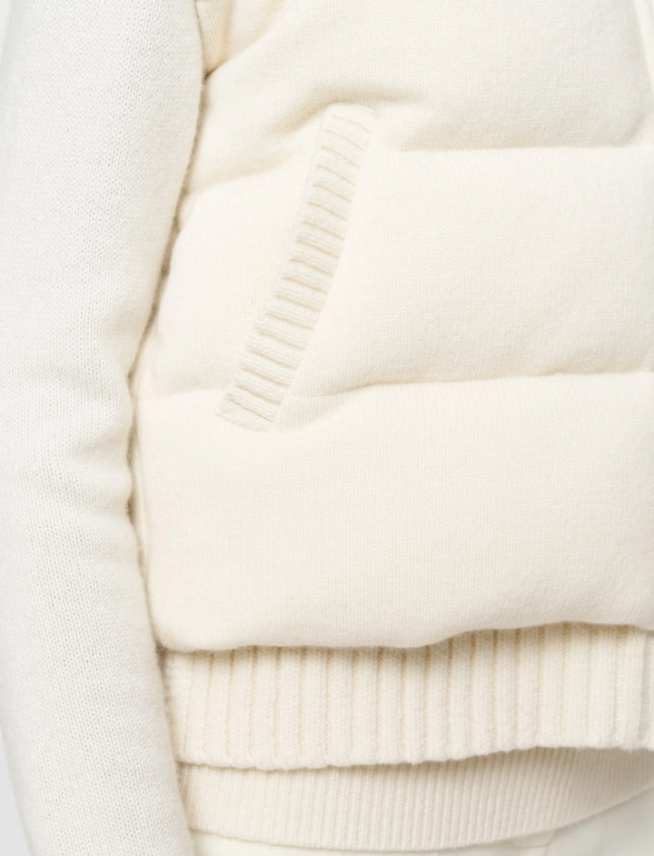 Close-up of a cream-colored sweater with ribbed texture
