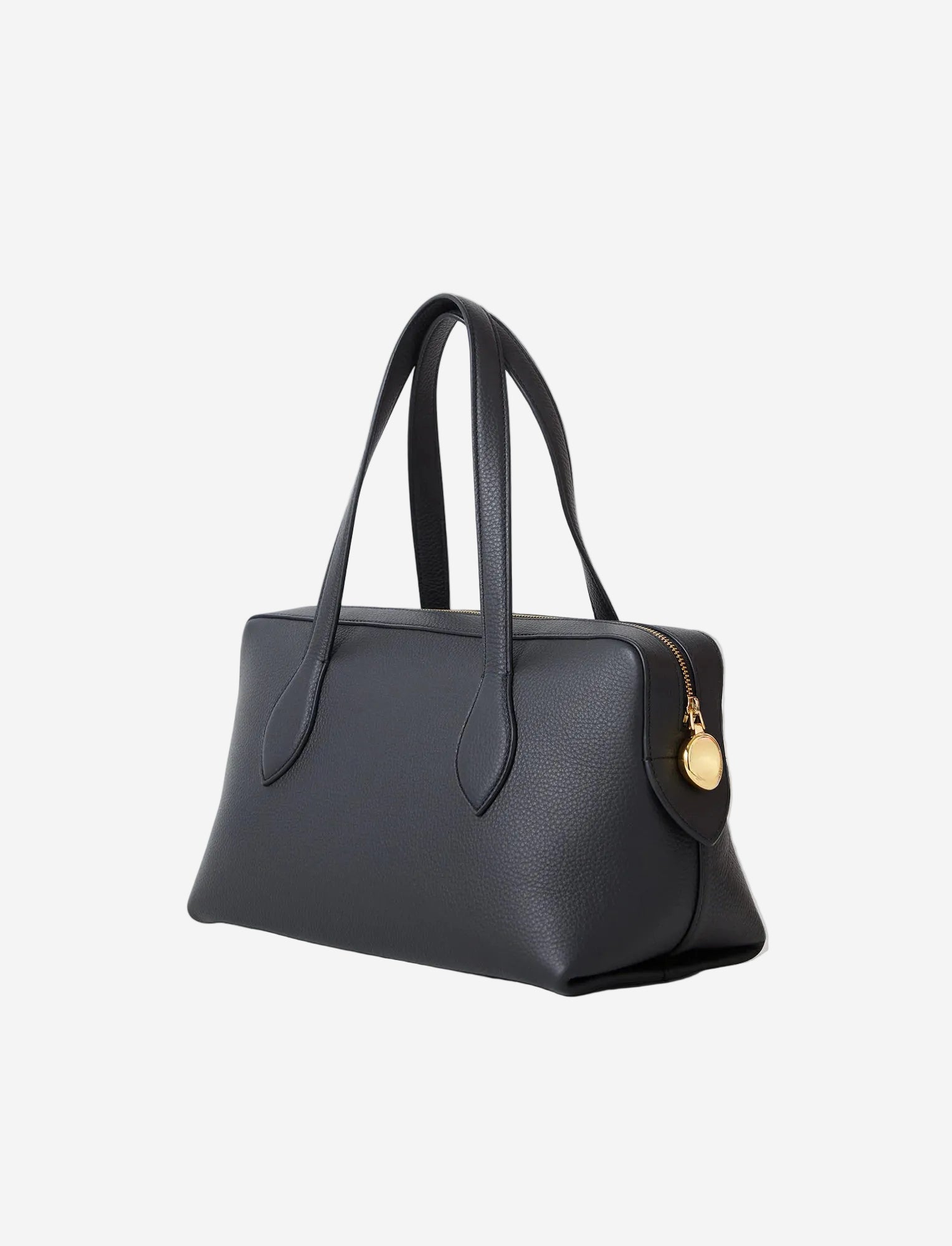 Black handbag with a gold tag on a light gray background