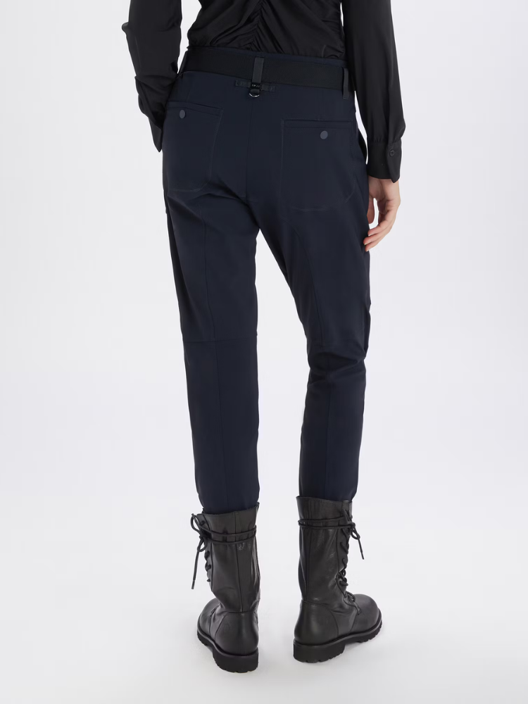 person wearing navy trousers and black boots