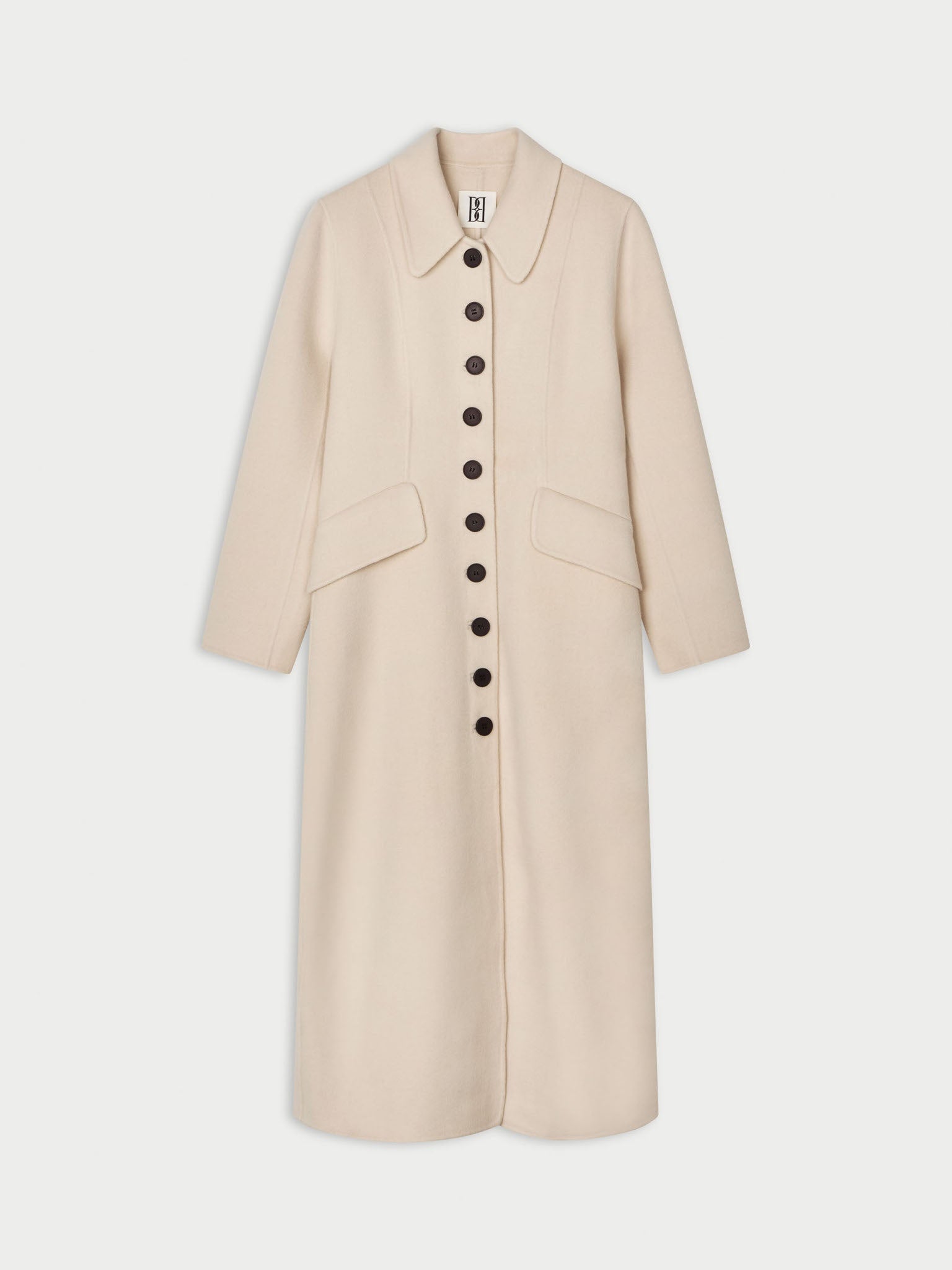 A light beige long coat by Malene Birger with a pointed collar, three-quarter sleeves, and a front button closure, shown against a light gray background.