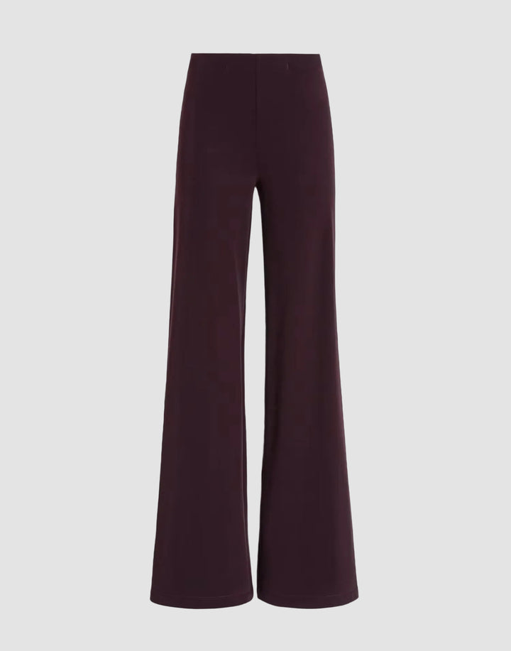 A pair of wide-leg trousers in a deep plum purple color, displayed against a solid black background.