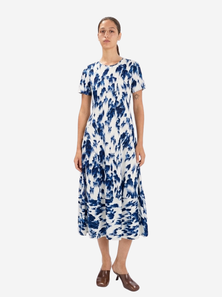 Woman wearing a blue and white floral dress on a white background