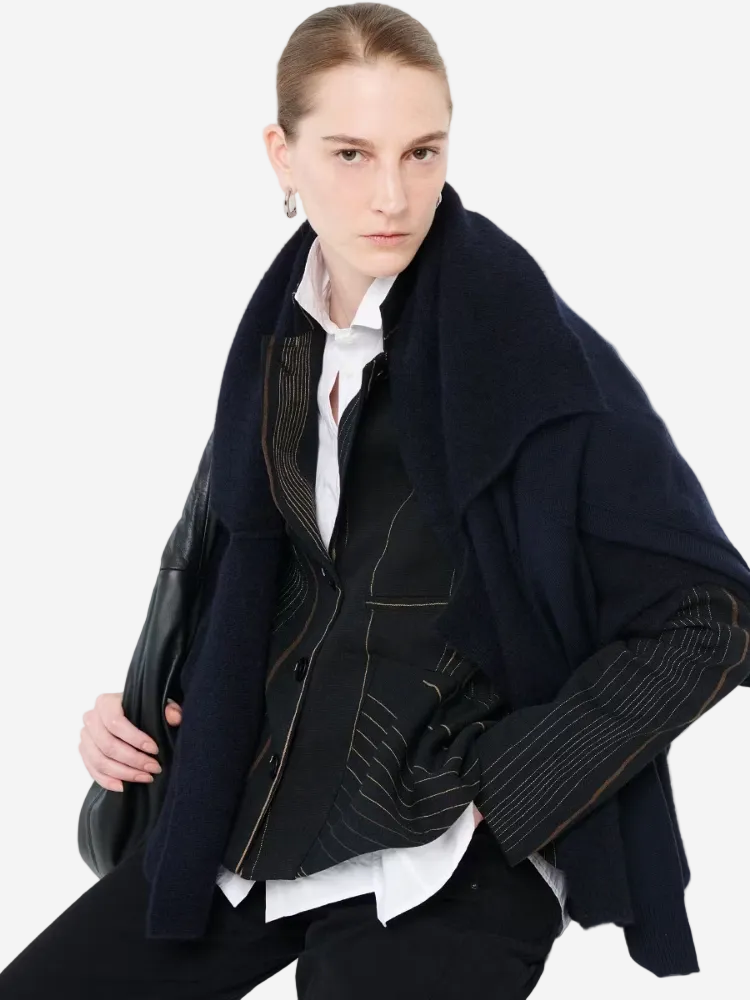 Person wearing a dark coat with a white background