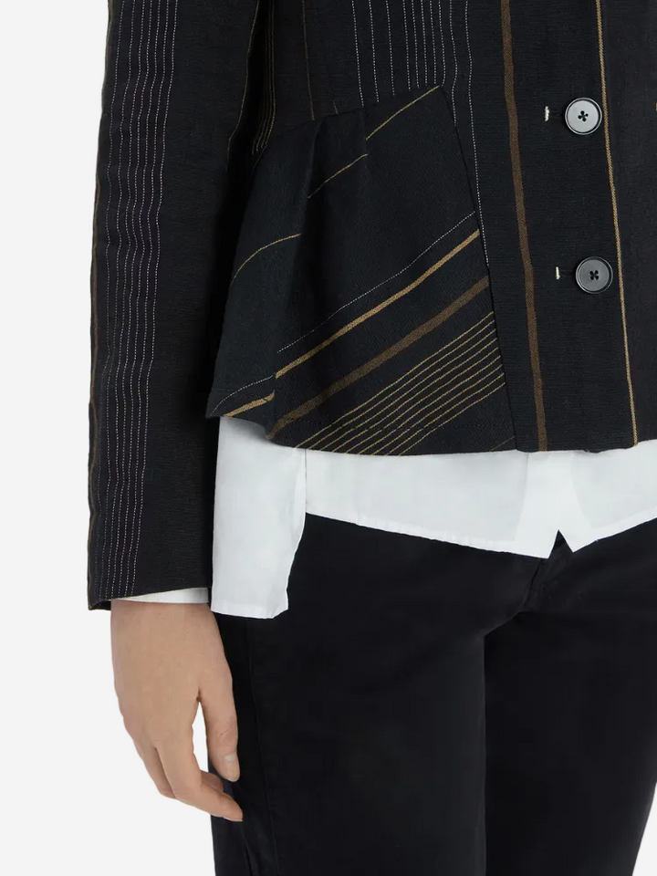Black jacket with gold accents worn over a white shirt and black pants on a white background