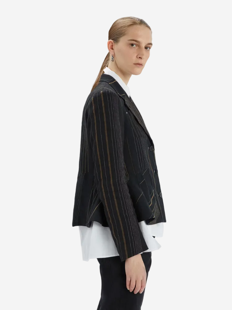 Woman wears white short and striped black jacket