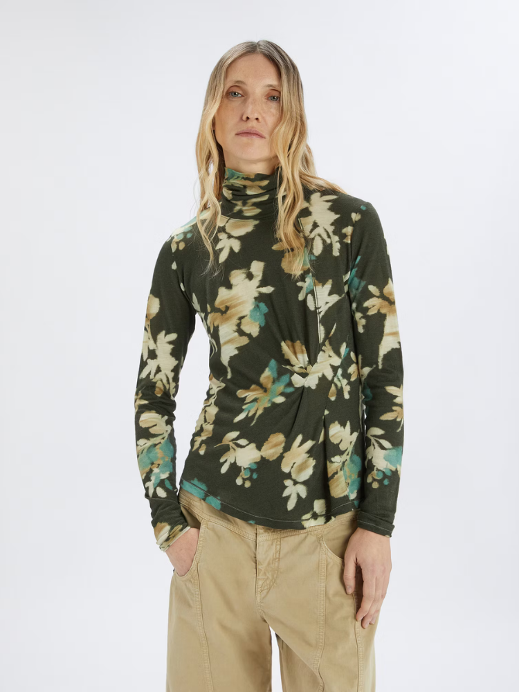 Woman wears a floral green top