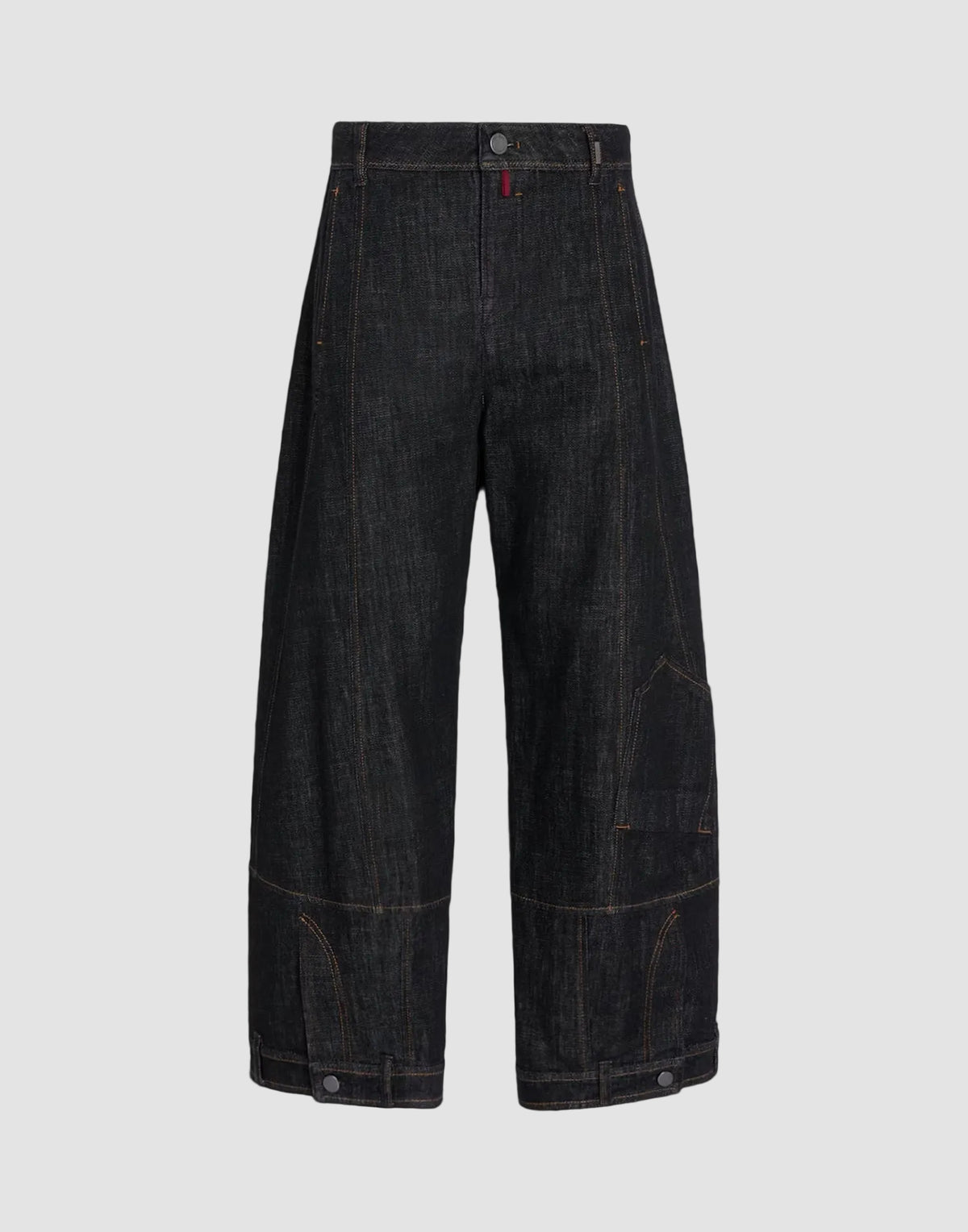 Dark indigo denim cropped pants with wide legs, featuring contrast orange stitching and a small red tab on the waistband, shown against a solid black background.