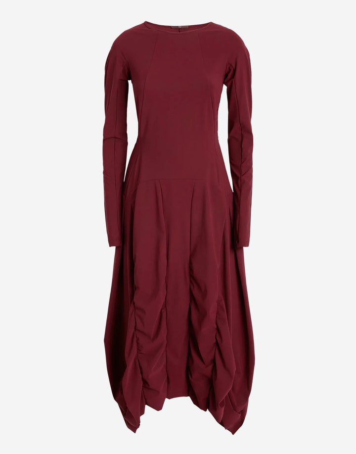 Maroon dress with long sleeves and a draped skirt on a white background