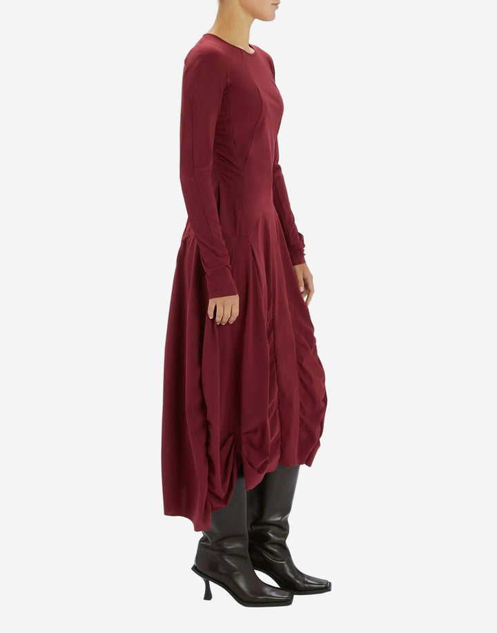 Maroon long dress worn by a person on a white background