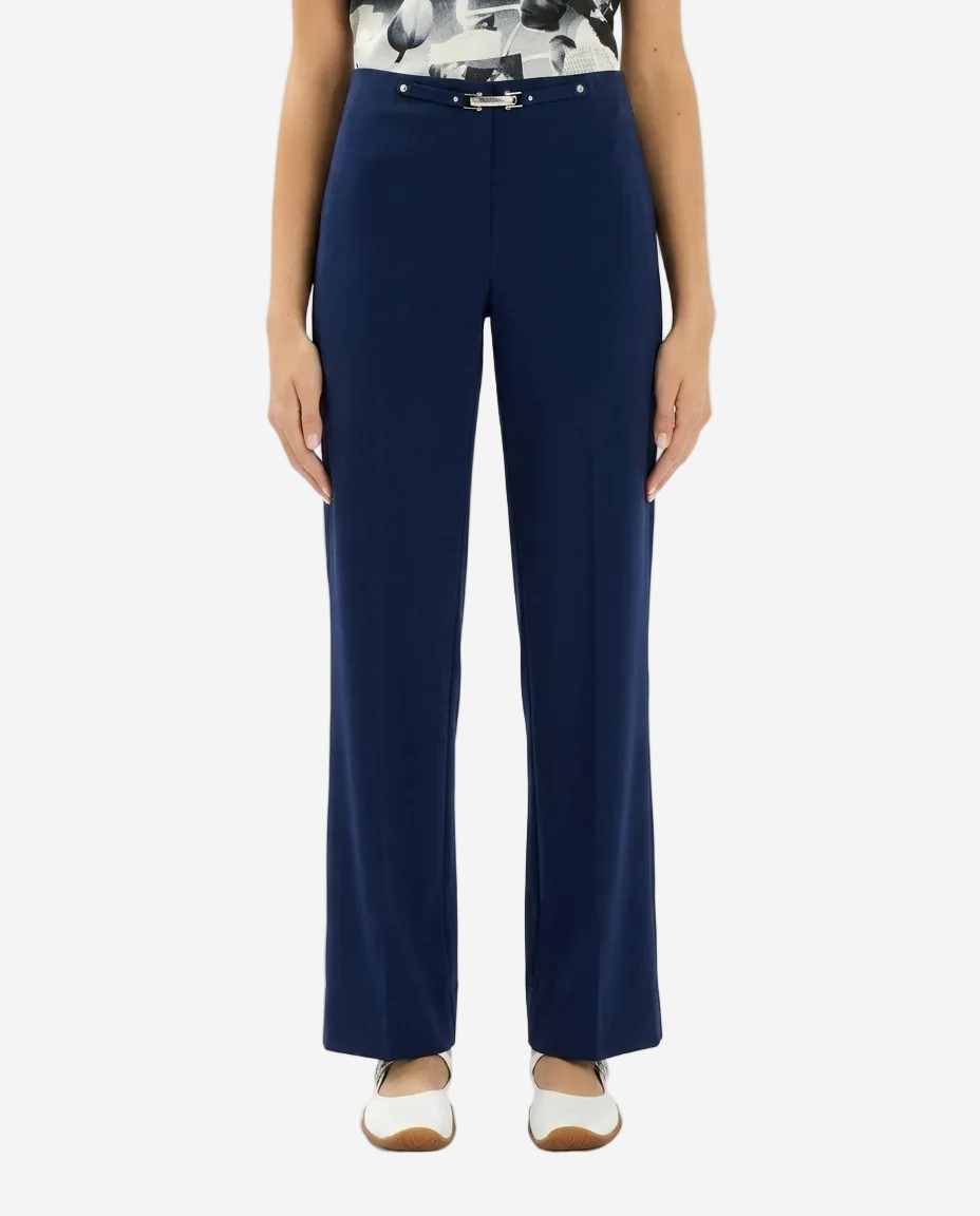 Navy blue pants worn by a person on a white background