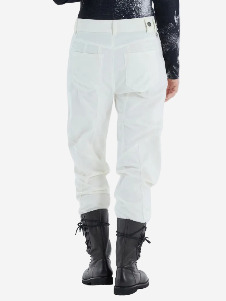 Person wearing light-colored pants and black boots on a white background