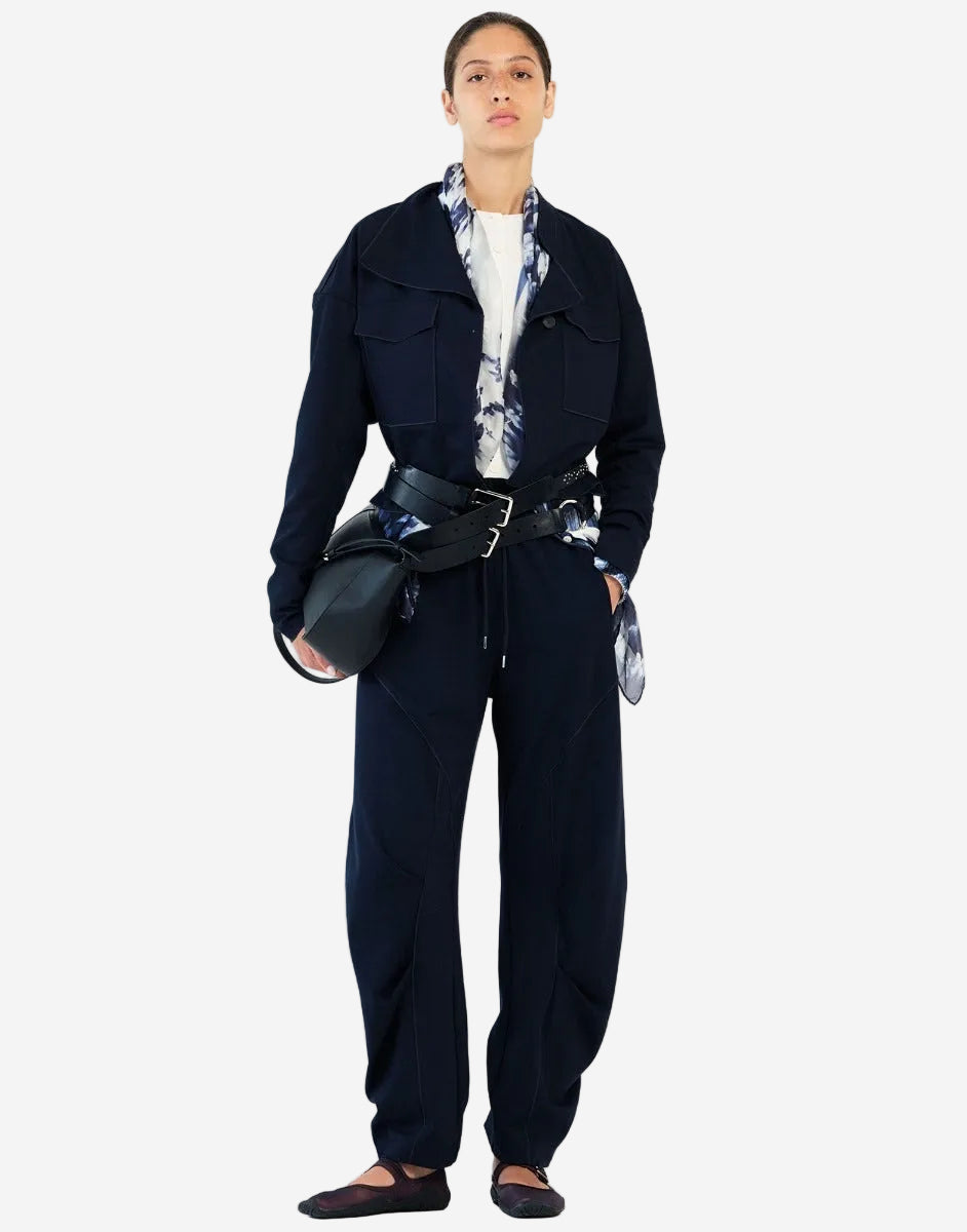 Person wearing a dark navy outfit with a white background