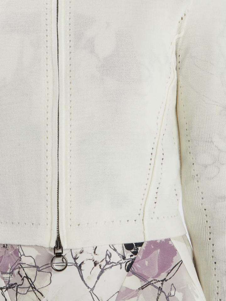 Close-up of a white garment with floral patterned tag.