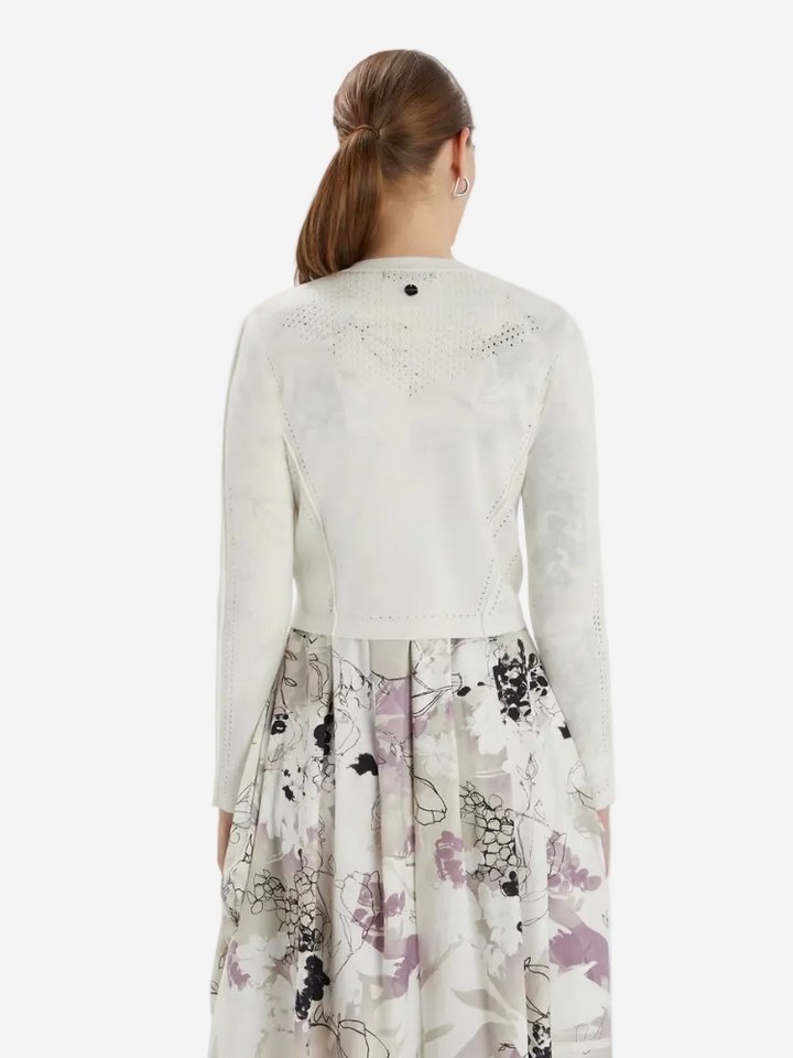 woman in a white cardigan and dress
