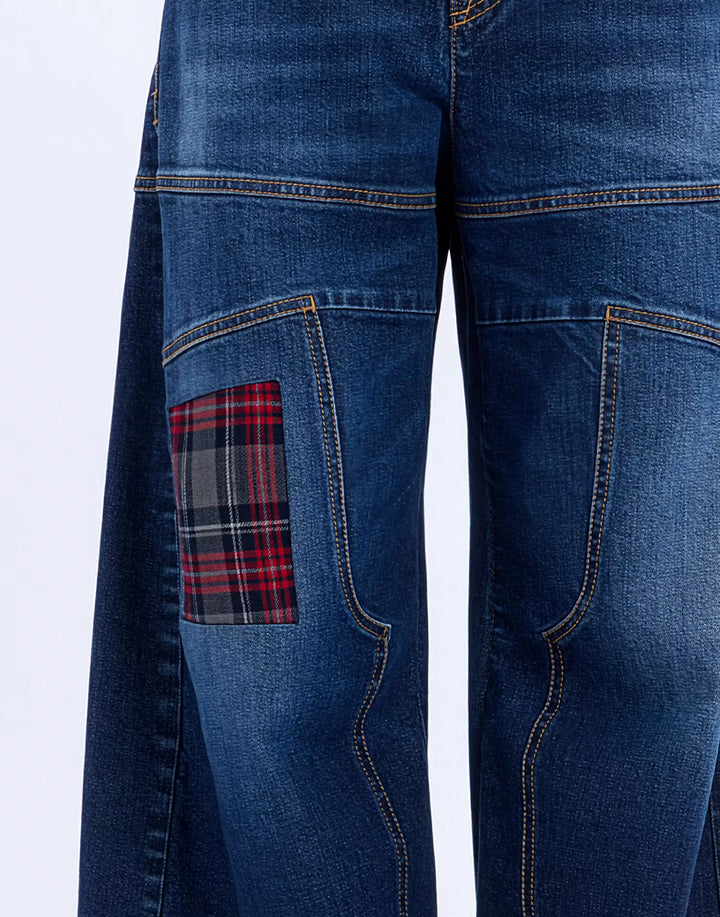 Close-up of the red tartan knee patch and contrast topstitching on the HIGH Snowdrift jeans