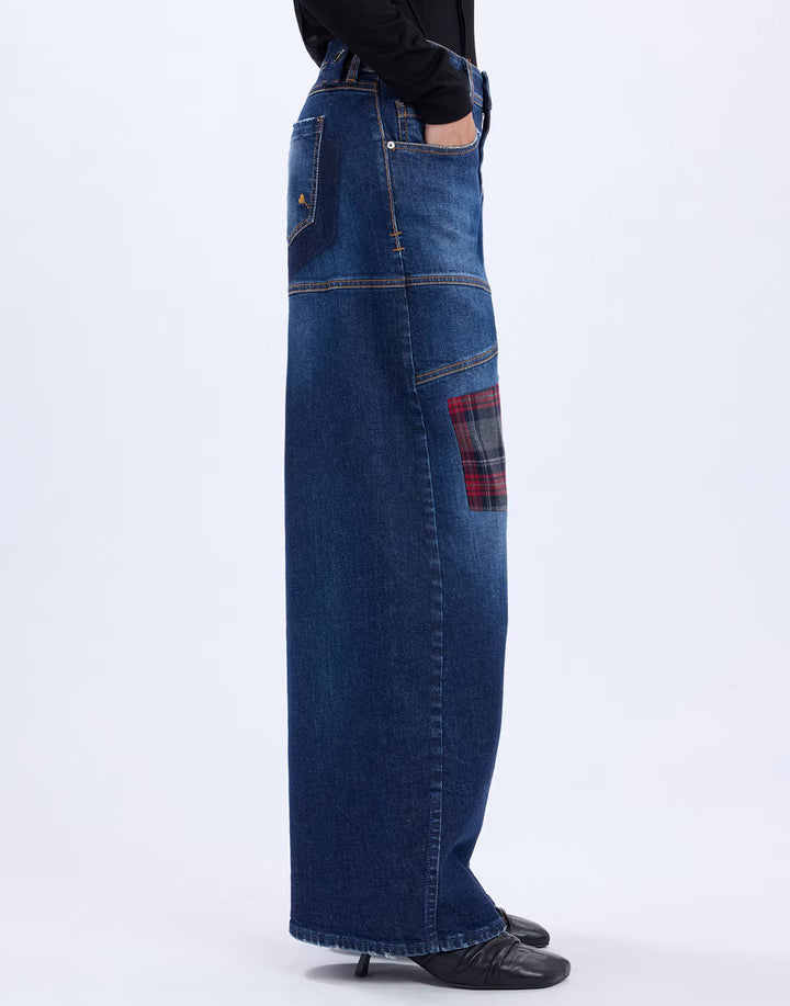 Side view of the HIGH Snowdrift jeans showing the red tartan knee patch and wide-leg silhouette