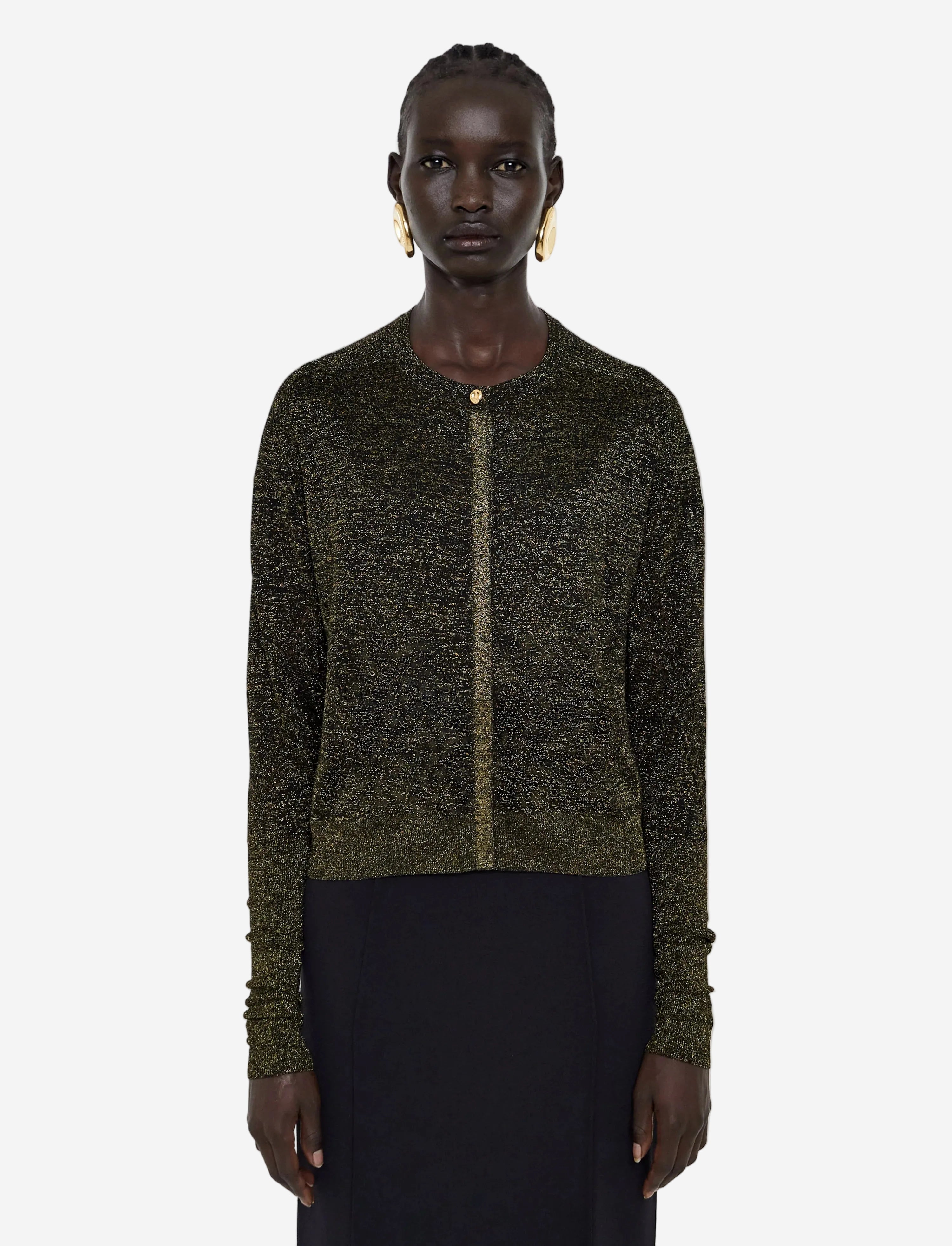 Person wearing a dark green knitted cardigan on a light gray background