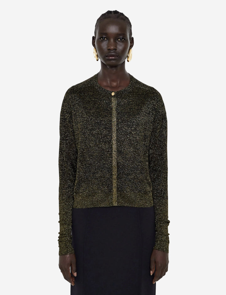 Person wearing a dark green knitted cardigan on a light gray background