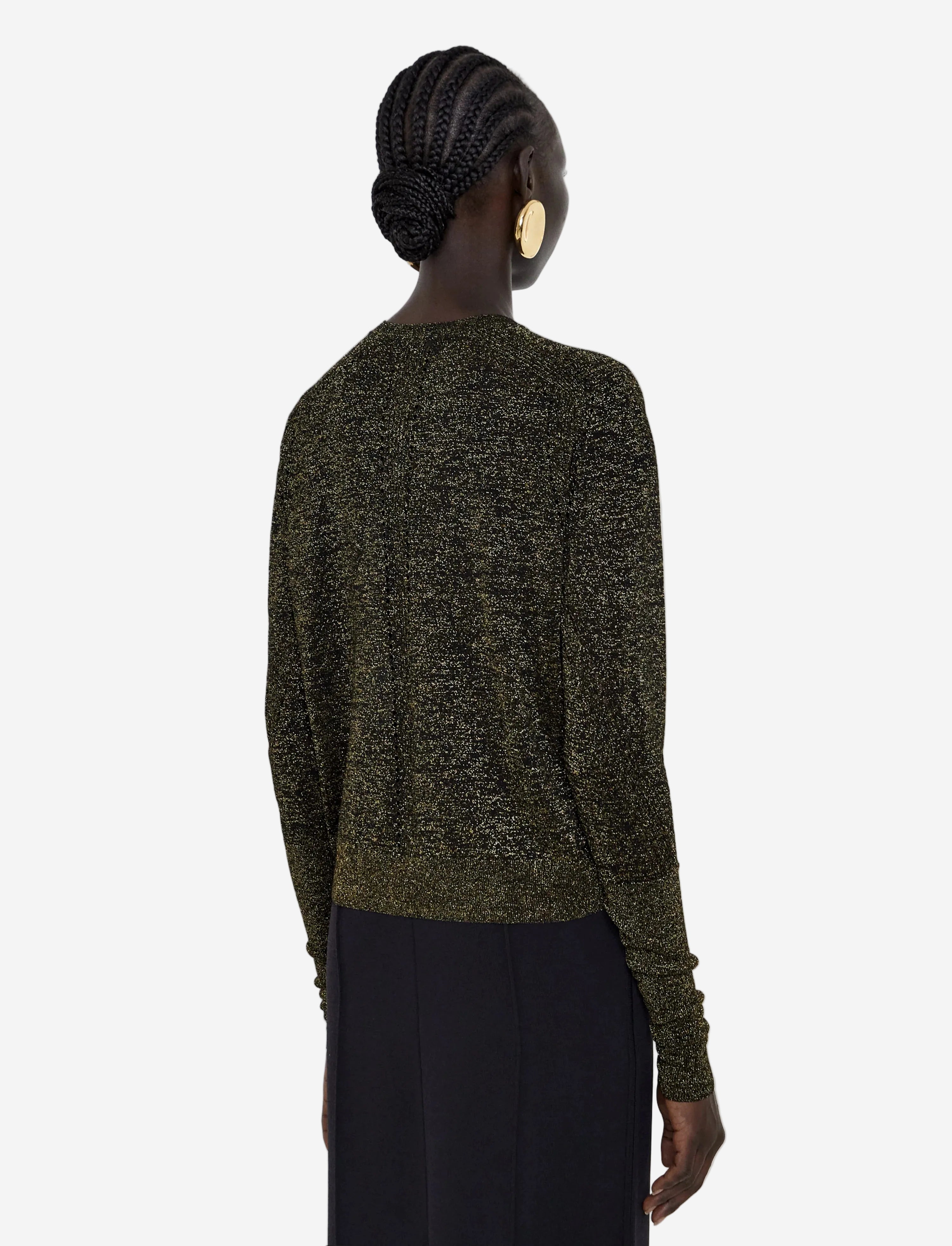 Person wearing a green sweater with a plain background