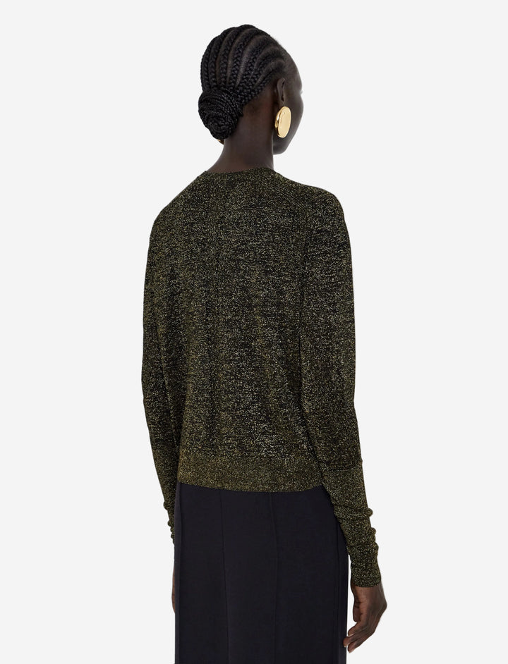 Person wearing a green sweater with a plain background