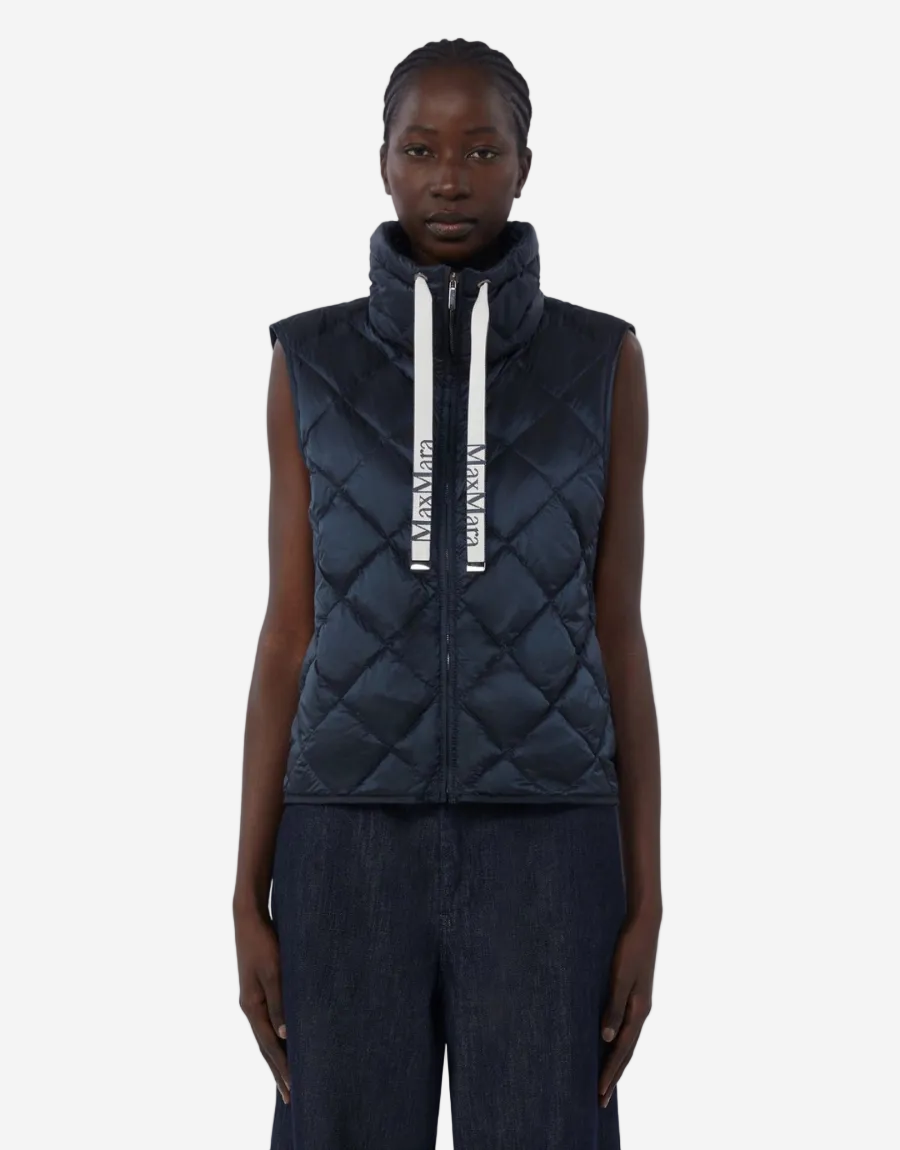 woman wears midnight puffer vest with maxmara ribbon ties