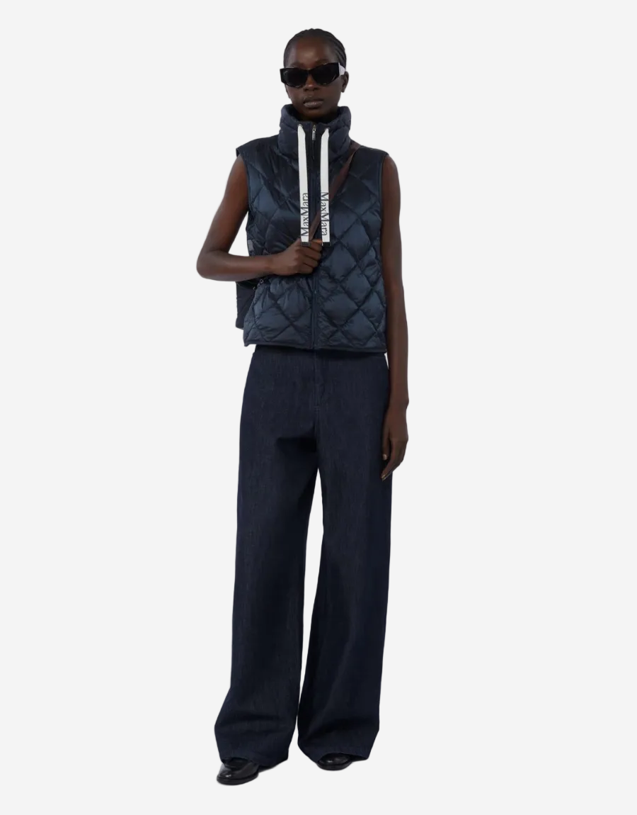 woman wears idnight nlue puffer and trousers