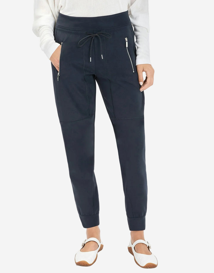Navy jogger pants worn by a person on a white background