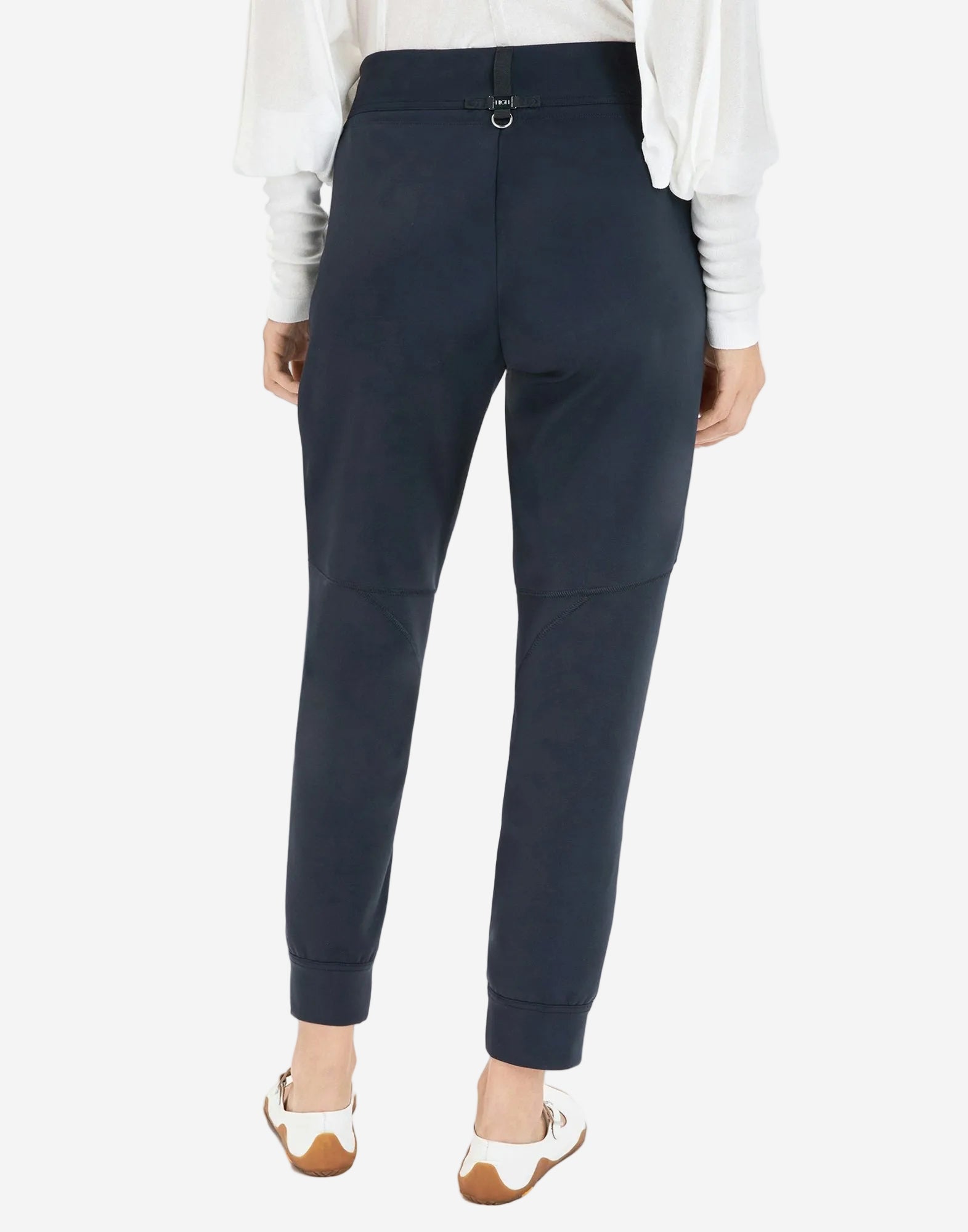 Navy jogger pants worn by a person on a white background