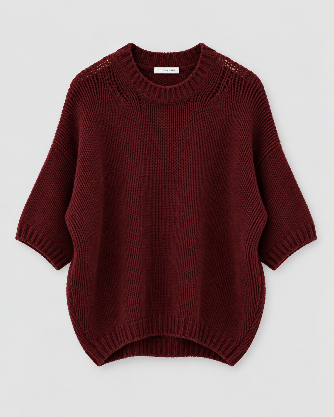 A dark burgundy knit sweater with a crew neck, 3/4 sleeves, and a ribbed hem, displayed flat against a light gray background.