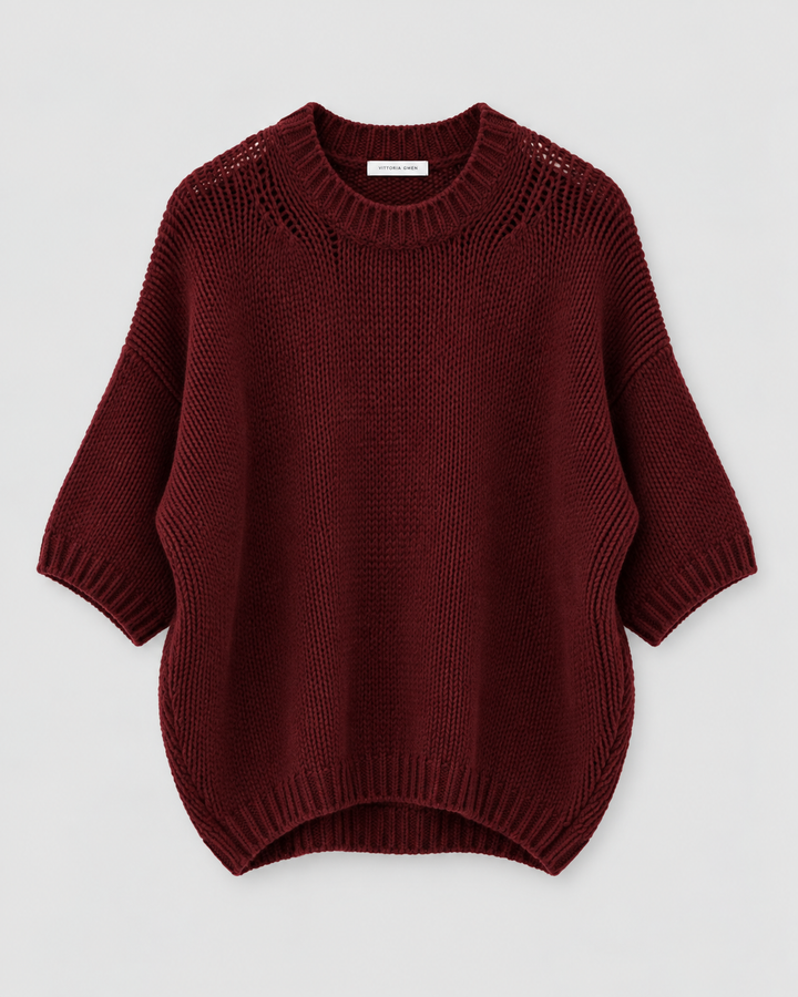 A dark burgundy knit sweater with a crew neck, 3/4 sleeves, and a ribbed hem, displayed flat against a light gray background.